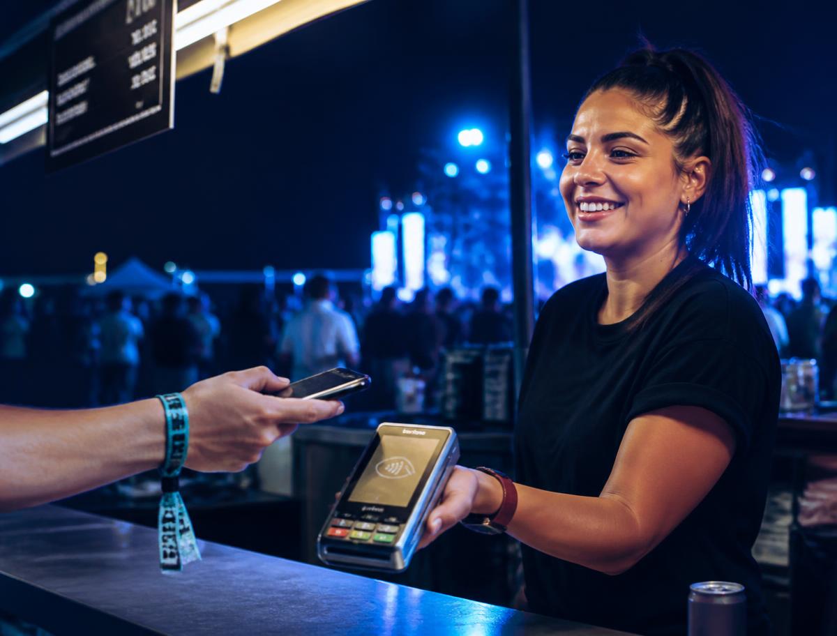 Vendor taking a contactless payment at a live event
